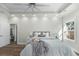 Comfortable main bedroom featuring tray ceiling with fan, wood-look floors, and natural light from a window at 39 Briarcliff Dr, Charleston, SC 29407