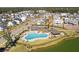 Community pool with lake view, lounge chairs, and sun umbrellas at 3902 Summerton St, Mount Pleasant, SC 29466
