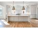 Bright kitchen featuring a large island, white cabinets, and hardwood floors at 3902 Summerton St, Mount Pleasant, SC 29466