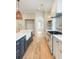 Bright kitchen featuring high-end appliances, a marble island with a farmhouse sink, and hardwood floors at 3902 Summerton St, Mount Pleasant, SC 29466