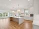 Spacious open-concept kitchen features a center island with a waterfall countertop and pendant lighting at 3902 Summerton St, Mount Pleasant, SC 29466