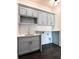 Functional laundry room with gray cabinets, countertop space, sink and tiled floor at 3902 Summerton St, Mount Pleasant, SC 29466