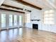 Bright living room with hardwood floors, a fireplace, built-in shelving, and French doors to the patio at 3902 Summerton St, Mount Pleasant, SC 29466