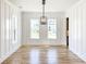Bright dining room featuring hardwood floors, modern lighting, and large windows with neighborhood views at 3902 Summerton St, Mount Pleasant, SC 29466