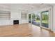 Bright living room with fireplace, built-in shelving, hardwood floors, and sliding glass doors to the deck at 3902 Summerton St, Mount Pleasant, SC 29466