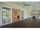 Covered porch with a fireplace, ceiling fans, and sliding glass doors leading to the living room at 3902 Summerton St, Mount Pleasant, SC 29466