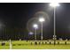 Night view of a soccer field with players practicing under bright stadium lights at 3902 Summerton St, Mount Pleasant, SC 29466