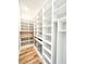 Spacious walk-in closet with custom shelving, wooden floors, and ample storage space for an organized wardrobe at 3902 Summerton St, Mount Pleasant, SC 29466
