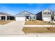 Beautiful single-story home showcasing a blue exterior, green lawn, paved driveway and attached garage at 400 Hampstead Ct, Summerville, SC 29486
