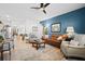 Spacious living room boasts modern decor, wood-look floors, and a large area rug with blue accent wall at 400 Hampstead Ct, Summerville, SC 29486