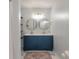Bathroom featuring double sink vanity with gold mirrors and a colorful rug accenting the neutral toned marble floor at 4336 Purdue Dr, North Charleston, SC 29418