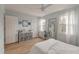 Bright bedroom with white furnishings, wood floors, lots of windows for natural light and a ceiling fan at 4336 Purdue Dr, North Charleston, SC 29418