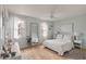 Bright bedroom with white furnishings, wood floors, lots of windows for natural light and a ceiling fan at 4336 Purdue Dr, North Charleston, SC 29418