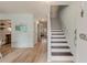 Bright entryway with stairs, wood flooring, and fresh paint, leading to other rooms at 4336 Purdue Dr, North Charleston, SC 29418