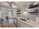 Bright kitchen features open shelving, white cabinets, quartz countertops, and stainless appliances at 4336 Purdue Dr, North Charleston, SC 29418