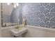 Charming powder room featuring a pedestal sink and bold blue and white patterned wallpaper at 4336 Purdue Dr, North Charleston, SC 29418