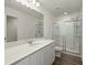Bathroom features a double sink, quartz countertop, a large mirror, and a glass-enclosed shower at 4368 Ocean Farm Dr, Summerville, SC 29485