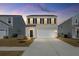 Two-story home featuring a two-car garage and neutral siding, set against a vibrant sunset sky at 4368 Ocean Farm Dr, Summerville, SC 29485