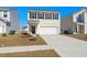Two-story home with a two-car garage, showcasing its front facade and landscaping on a sunny day at 4368 Ocean Farm Dr, Summerville, SC 29485