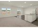 Bright living space featuring neutral carpet, a modern kitchen, and access to the backyard through sliding glass doors at 4368 Ocean Farm Dr, Summerville, SC 29485