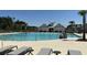 A community pool with chairs and umbrellas, with a pool house in the background at 4368 Ocean Farm Dr, Summerville, SC 29485