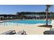 A large community pool has several water features and is surrounded by lounge chairs and tables at 4368 Ocean Farm Dr, Summerville, SC 29485