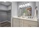 Bathroom featuring double sinks, a large mirror and a view into the bedroom at 4618 Moss Ct, Charleston, SC 29420