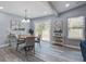 Sunlit dining area features wood floors, a round table, and sliding glass doors to backyard at 4618 Moss Ct, Charleston, SC 29420