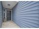 Inviting entryway showcasing a stylish front door and light blue horizontal siding with a decorative lantern at 4618 Moss Ct, Charleston, SC 29420