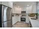 Well-lit kitchen featuring stainless steel appliances, white cabinets and stone countertops at 4618 Moss Ct, Charleston, SC 29420
