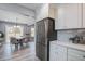 Modern kitchen with stainless steel refrigerator, white cabinets, countertop and dining area at 4618 Moss Ct, Charleston, SC 29420