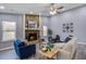 Spacious living room with stone fireplace, neutral walls, wood floors and ceiling fan at 4618 Moss Ct, Charleston, SC 29420