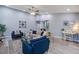 Bright living room featuring a ceiling fan, neutral walls, wood floors and blue armchairs at 4618 Moss Ct, Charleston, SC 29420
