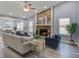 Spacious living room with a stone fireplace, hardwood floors, and comfortable seating, ideal for Gathering gatherings at 4618 Moss Ct, Charleston, SC 29420