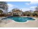 Backyard featuring a sparkling pool with an integrated hot tub, surrounded by a concrete patio for outdoor enjoyment at 4634 O'Hear Ave, North Charleston, SC 29405