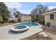 Backyard featuring a sparkling pool with an integrated hot tub, surrounded by a concrete patio for outdoor enjoyment at 4634 O'Hear Ave, North Charleston, SC 29405
