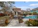 Inviting backyard features a pool, jacuzzi, wooden deck, stone walkway and well-manicured landscaping at 4634 O'Hear Ave, North Charleston, SC 29405
