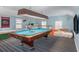 Upstairs game room with pool table, colorful carpet and light blue walls for entertaining and relaxation at 4634 O'Hear Ave, North Charleston, SC 29405