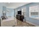 Living room with daybed, television, and an exterior door leading to the pool area at 4634 O'Hear Ave, North Charleston, SC 29405