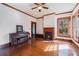 Living room showcasing hardwood floors, a fireplace, and piano at 4634 O'Hear Ave, North Charleston, SC 29405