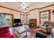 Cozy living room with hardwood floors, a fireplace, natural light, and comfortable seating at 4634 O'Hear Ave, North Charleston, SC 29405