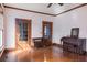 Living room with hardwood floors and original wood trim featuring doors to other rooms at 4634 O'Hear Ave, North Charleston, SC 29405