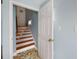 Staircase leading upstairs featuring wood stairs and a white door at 4634 O'Hear Ave, North Charleston, SC 29405