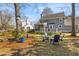 Large backyard with mature trees, blue chairs, screened-in porch, and a well-maintained lawn at 471 Springfield Rd, Mount Pleasant, SC 29464