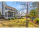 Wide view of the home's backyard, featuring the screened in porch, patio and spacious lawn at 471 Springfield Rd, Mount Pleasant, SC 29464