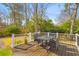 Outdoor deck space with a table, chairs, and railings overlooking the spacious backyard at 471 Springfield Rd, Mount Pleasant, SC 29464