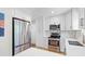 Well-equipped kitchen with stainless steel appliances, white cabinets, and elegant backsplash at 471 Springfield Rd, Mount Pleasant, SC 29464