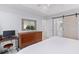 Bright main bedroom with a sliding barn door to ensuite, a dresser, and a workspace at 471 Springfield Rd, Mount Pleasant, SC 29464