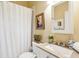 Bright bathroom with neutral tones featuring vanity with sink, mirror, and shower with curtain at 48 Montagu St # B, Charleston, SC 29401