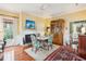 Bright dining room featuring hardwood floors, a fireplace, and a stylish floral chair set at 48 Montagu St # B, Charleston, SC 29401